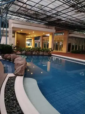 a large swimming pool in a building at Doc Odette Studio Staycation in Manila
