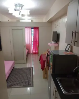 a room with a kitchen and a living room at 10th Floor Staycation in Manila