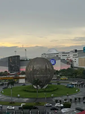 a large metal object in a parking lot in a city at 10th Floor Staycation in Manila