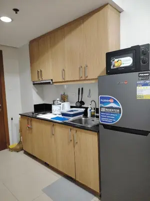 a kitchen with a sink and a refrigerator at AteAbyPlace830 in Manila