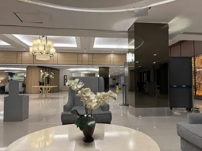 a lobby with a vase of flowers on a table at AteAbyPlace830 in Manila