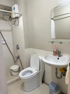 a bathroom with a toilet and a sink at 1BR LaVerti Cloud Nine Suite Family affordable staycation in Manila
