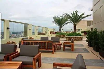 a patio with chairs and tables on a building at 1BR LaVerti Cloud Nine Suite Family affordable staycation in Manila