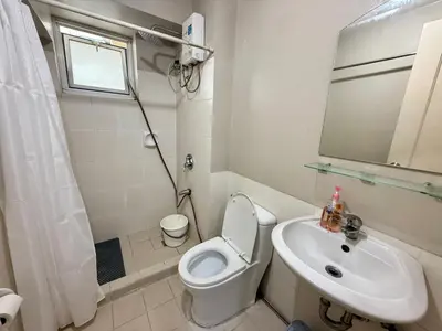 a white bathroom with a toilet and a sink at 1BR LaVerti Cloud Nine Suite Family affordable staycation in Manila
