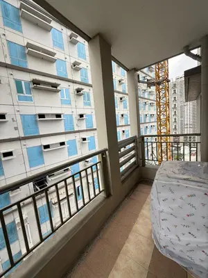 a balcony with a bed and two large windows at 1BR LaVerti Cloud Nine Suite Family affordable staycation in Manila