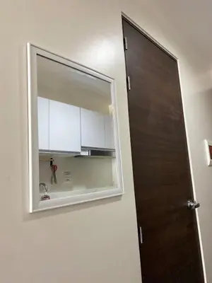 a mirror on a wall next to a kitchen at Sunrise Haven in Makati AIR Residences in Manila