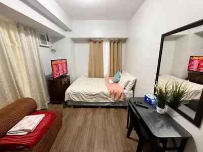 a living room with two beds and a couch at 1BR LaVerti Cloud Nine Suite Family Affordable Staycation in Manila