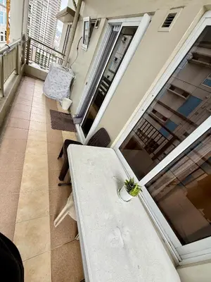 a white table in a room with a balcony at 1BR LaVerti Cloud Nine Suite Family Affordable Staycation in Manila
