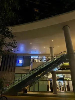 an escalator in front of a building at night at Affordable Condo in Makati Air Residences in Manila