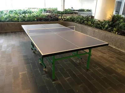 a ping pong table in the middle of a room at Affordable Condo in Makati Air Residences in Manila