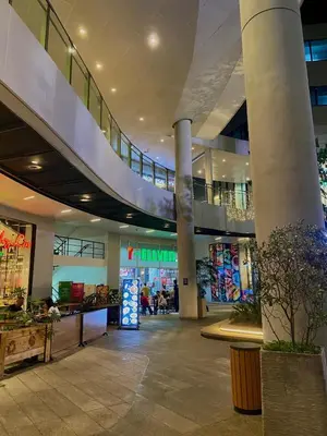 a shopping mall with a staircase in the middle at Affordable Condo in Makati Air Residences in Manila