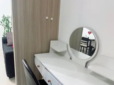 a bathroom with a mirror and a white sink at Shore Residences Moa View in Manila
