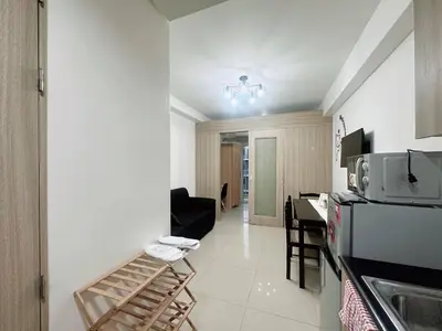 a kitchen with a counter and a table in a room at Shore Residences Moa View in Manila