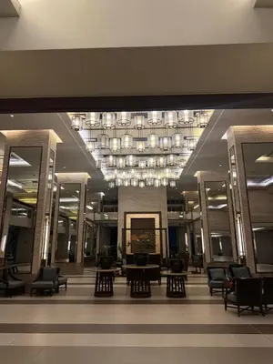 a lobby with chairs and tables in a building at Casita avec Amour at Lumiere Residences in Manila