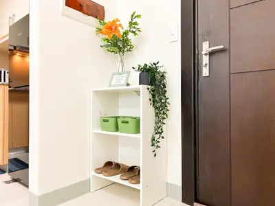 a shelf in the hallway of a house with shoes at Prime BGC 1BR Near Grand Hyatt & Malls #upt215e in Manila
