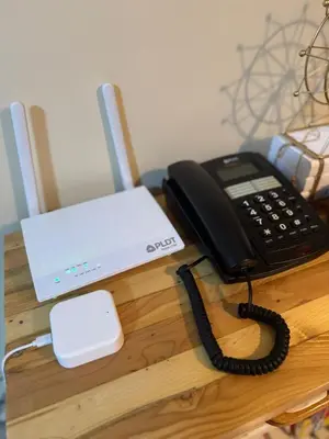 a phone and a laptop on a table at Family Comfort Zone Staycation at Greenhills in Manila