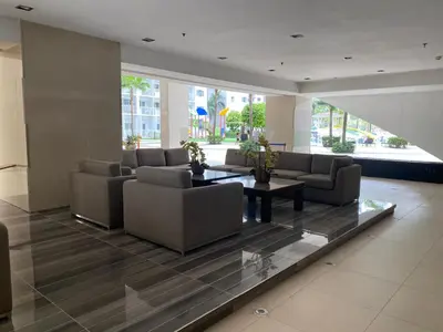 a lobby with couches and a table in a building at Shore - Spacious Room with Balcony - 52D in Manila