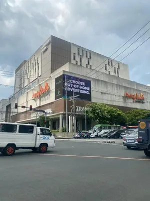 a white van parked in front of a building at Shore - Spacious Room with Balcony - 52D in Manila