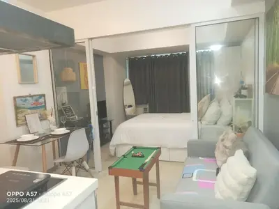 a living room with a couch and a bed at Casa azure by B&M STAYCATION at Paranque in Manila