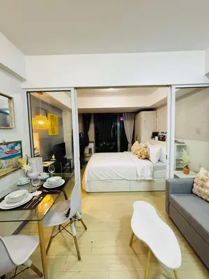 a room with a bed and a table and a couch at Casa azure by B&M STAYCATION at Paranque in Manila
