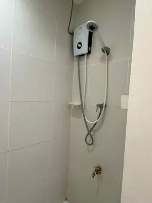 a shower with a shower head in a bathroom at Condo Unit, 2 Beds, Wi-fi, Free Amenities in Manila