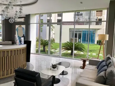 a living room with a couch and a table at Kasara Pasig Staycation in Manila