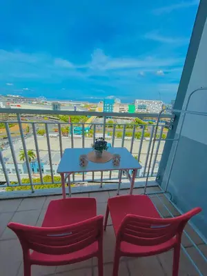 a table and two chairs on a balcony with the beach at Milk and honey condotel in Manila