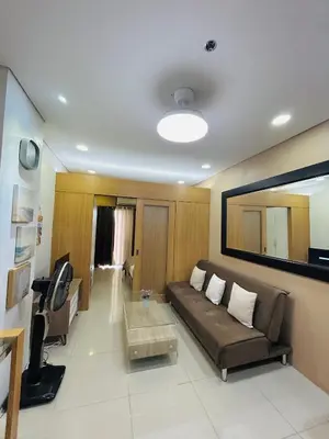 a living room with a couch and a table at Milk and honey condotel in Manila