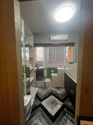 a bathroom with a view of a room with a window at Breeze Residences Condos in Manila
