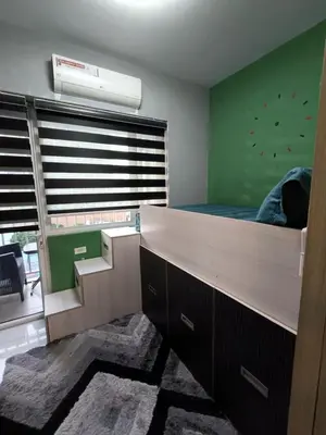 a bedroom with a bed and a large window at Breeze Residences Condos in Manila