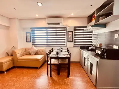 a living room with a table and a couch at G's Bnb in Manila