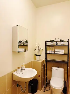 a bathroom with a toilet and a sink at The Camden Place Family Group Apartment Condo Unit in Manila