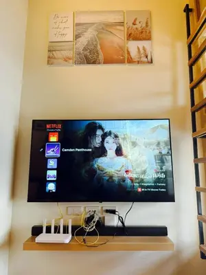 a flat screen tv hanging on a wall at The Camden Place Family Group Apartment Condo Unit in Manila