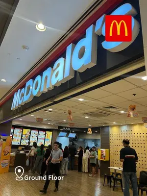 a mcdonalds restaurant with people standing in front of it at 2 Bedroom Unit with Queen-sized Beds near NAIA T3 in Manila
