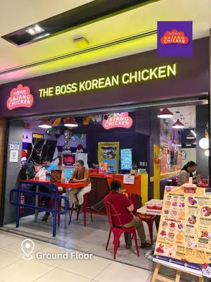 a group of people sitting at tables in a restaurant at 2 Bedroom Unit with Queen-sized Beds near NAIA T3 in Manila