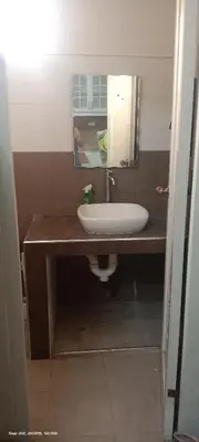 a bathroom with a sink and a mirror at Victoria's capsule bed in Manila