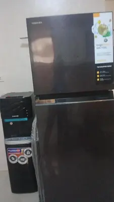 a microwave oven sitting on top of a refrigerator at Victoria's capsule bed in Manila