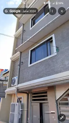 a building with a window on the side of it at Victoria's capsule bed in Manila