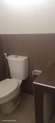 a bathroom with a white toilet and a counter at Victoria's capsule bed in Manila