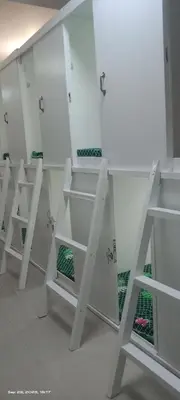 a row of white shelves in a room at Victoria's capsule bed in Manila