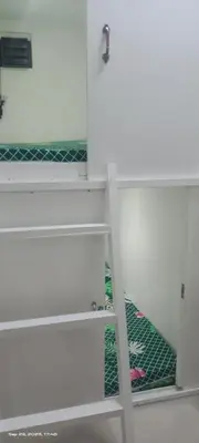a white shelf with a door in a room at Victoria's capsule bed in Manila