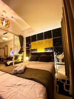 a bedroom with a large bed in a room at Azure Luxe Suites in Azure Bicutan Near NAIA and MOA in Manila