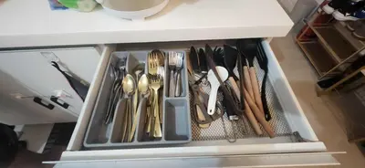 a drawer filled with utensils in a cabinet at Azure Luxe Suites in Azure Bicutan Near NAIA and MOA in Manila