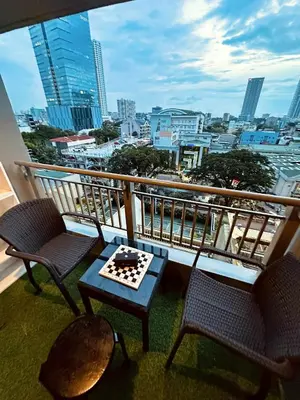 a balcony with two chairs and a chess board at La Verti Residences Pasay City in Manila