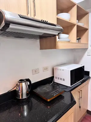 a kitchen with a microwave and a toaster oven at La Verti Residences Pasay City in Manila
