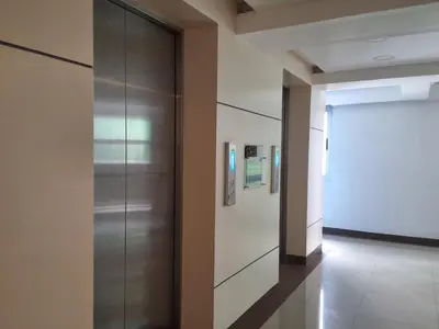 a hallway in a building with a elevator at The Dwelling Place at Metrotowne Las Pinas in Manila