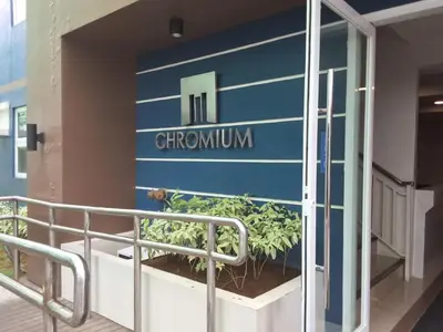 a sign on the side of a building with a plant at The Dwelling Place at Metrotowne Las Pinas in Manila