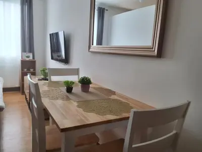 a dining room table with chairs and a mirror at The Dwelling Place at Metrotowne Las Pinas in Manila