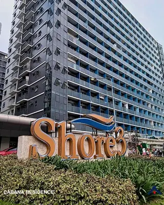 a sign in front of a large building at Cabana Residence at Shore 3 - MOA Complex in Manila