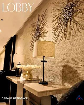 a table with two lamps on it in a room at Cabana Residence at Shore 3 - MOA Complex in Manila
